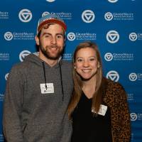 two alumni lakers smiling for picture